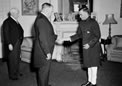 The newly appointed High Commissioner for India in Australia, Mr Parakat Achutha  Menon presents his Letter of Commission to the Administrator of the Commonwealth of Australia, Sir John Northcott, at Admiralty House, Sydney, in October 1956. 
Source: National Archives of Australia: A1501, A423/1




